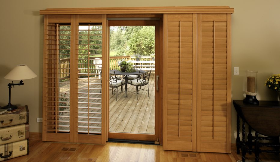 Bypass wood patio door shutters in a Raleigh living room Bypass wood patio door shutters in Raleigh living room